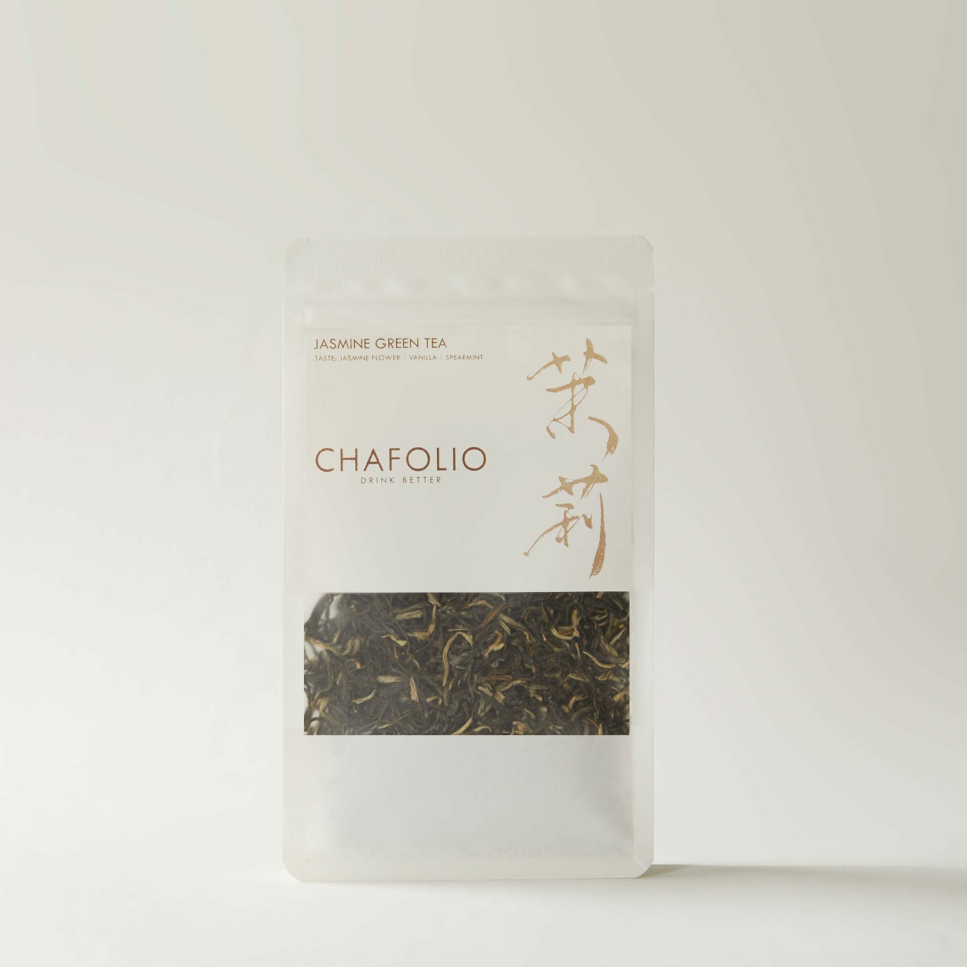A clear, resealable pouch of Chafolio Jasmine Green Tea with visible tea leaves at the bottom and minimalist white and gold labeling.