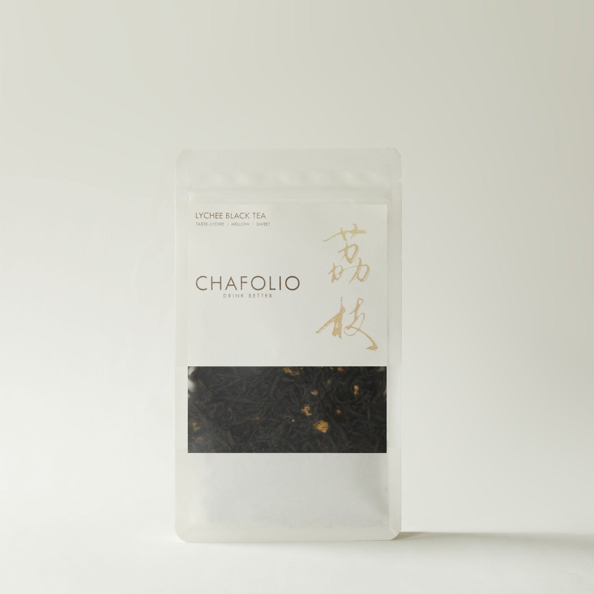 A clear, resealable bag of Chafolio Lychee Black Tea with loose natural tea leaves and gold Chinese characters on the label is displayed against a plain light background.