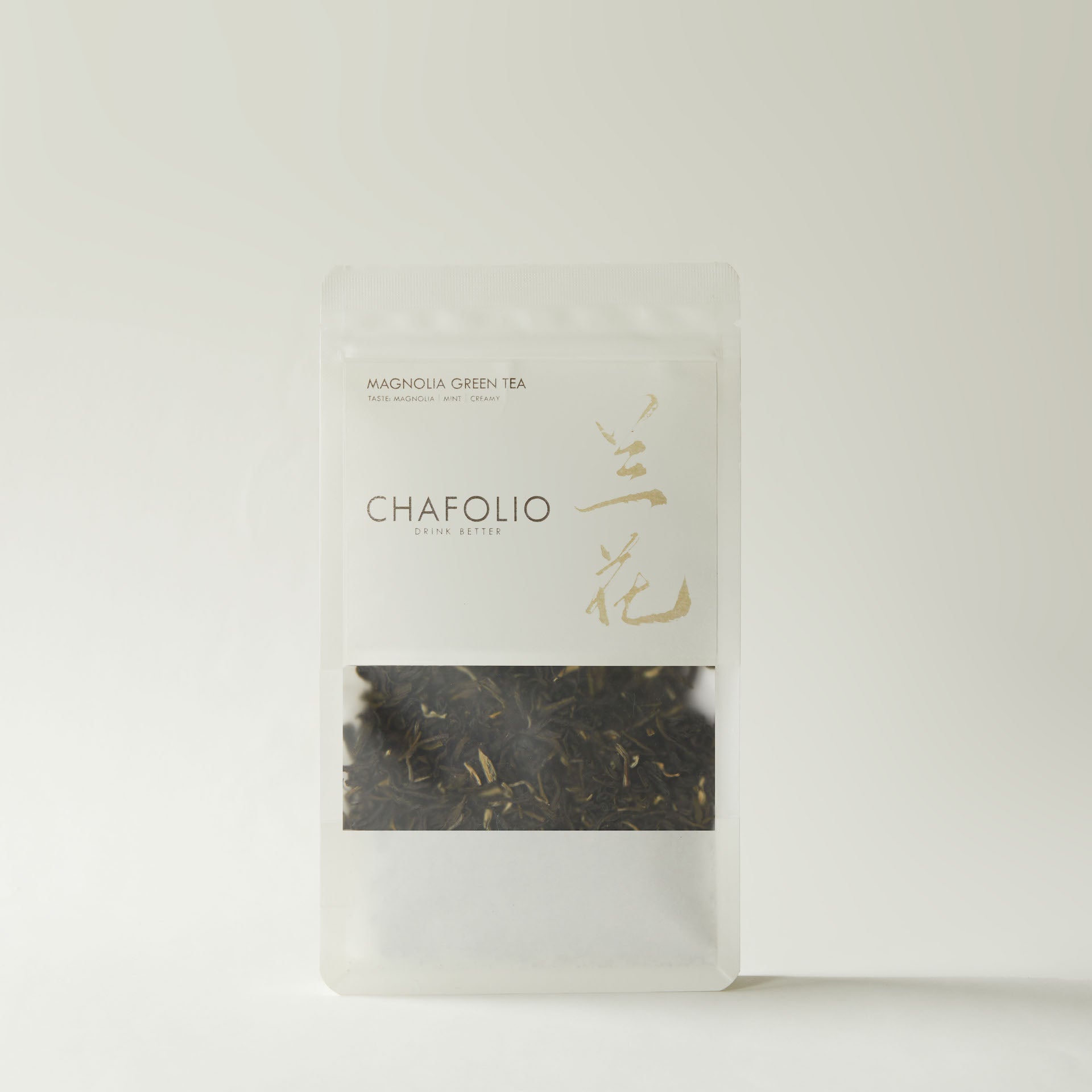 A clear stand-up pouch of Chafolio Magnolia Green Tea, filled with loose leaf, magnolia-scented green tea, is displayed against a plain background.