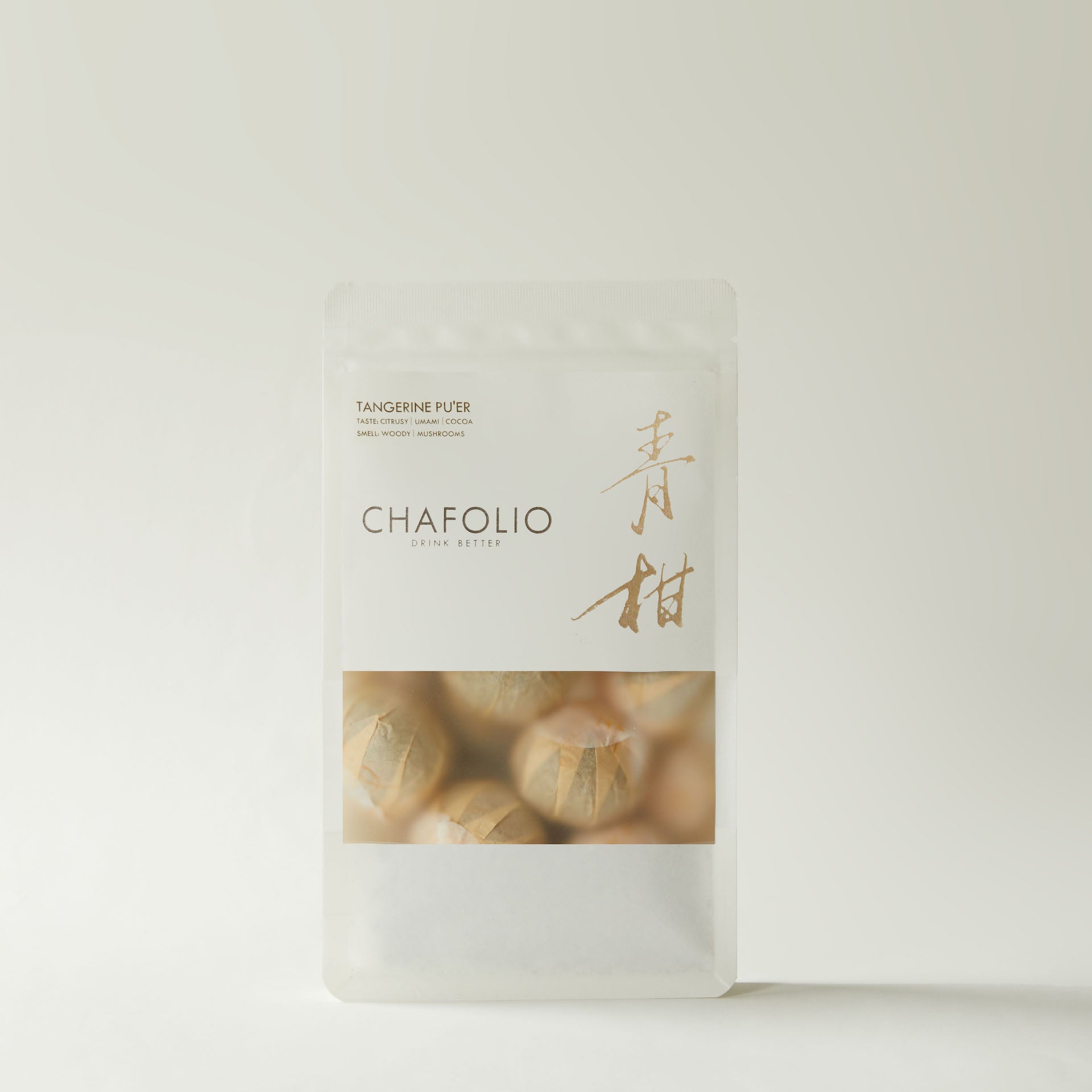 A white, rectangular, resealable pouch labeled "Chafolio Tangerrine Pu'er" features Chinese characters and wrapped tea balls, highlighting its blend of pu-er tea and green tangerine peel (Xiao Qing Gan) on the front.