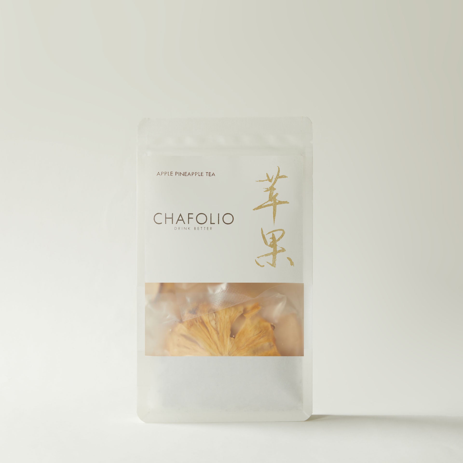 A resealable pouch labeled "Chafolio Apple Pineapple Tea" shows dried pineapple slices inside, set against a light background—ideal for anyone wanting a no-sugar-added fruit tea.