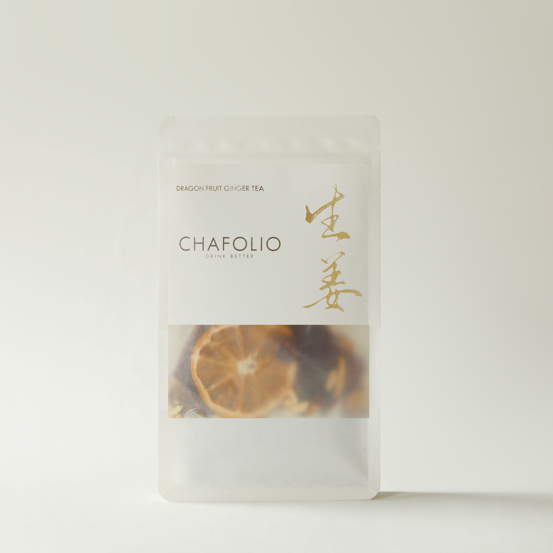 A white, resealable Chafolio Dragonfruit Ginger Tea bag features dried citrus slice imagery, showcasing a flavorful blend designed for digestive support.